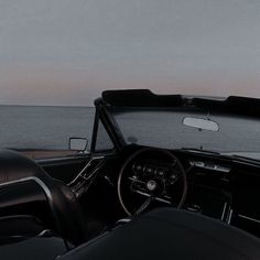 the interior of an old fashioned car by the ocean