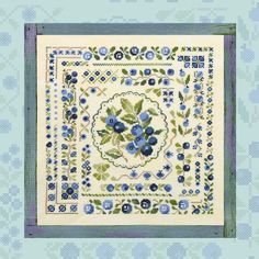 a blue and white square with flowers on the border is featured in this quilt pattern