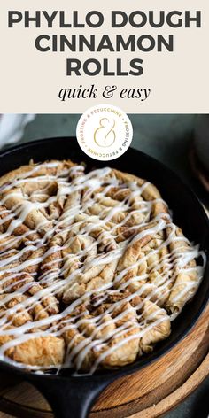 a skillet filled with cinnamon rolls and drizzled with icing