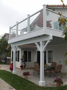 a white house with an attached deck and patio