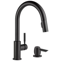 a black faucet with two handles and nozzles on the side, in front of a white background