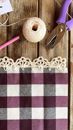 some yarn and scissors on a wooden table