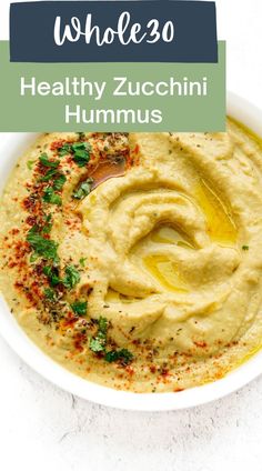 hummus in a white bowl with the title whole 30 healthy zucchini hummus