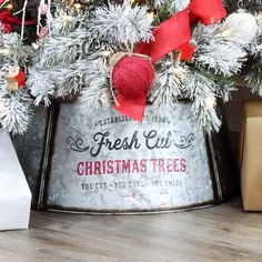 a christmas tree in a metal bucket with red and white ornaments