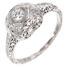 Belais diamond engagement ring. 18k white gold original Art Deco circa 1920s with highly detailed engraving and pierced filigree work. The center is set with an original transitional European cut sparkly Diamond. 1 round Diamond, approx. total weight .12cts, H, VS1 Size 6.5 and sizable 18k white gold Tested and stamped: 18k Hallmark: Belais 2.1 grams Width at top: 8.68mm Height at top: 6.1mm Width at Bottom: 1.43mm Art Deco Gold Engagement Ring, 1910s Engagement Ring, Art Deco Engagement Ring Gold, Double Diamond Engagement Ring, 1920s Engagement Ring Vintage, 1920s Engagement Ring, Argentium Silver Jewelry, Antique Jewelry Rings, Art Deco Gold