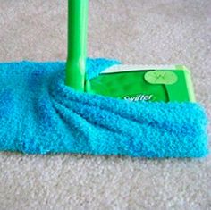 a green mop is laying on the carpet