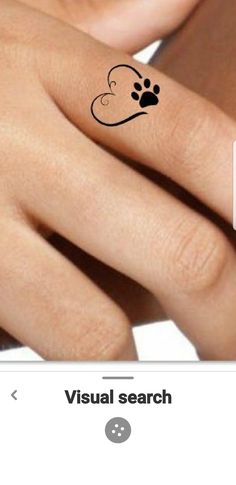 a woman's hand with a dog paw tattoo on her left wrist and the word visual search below it