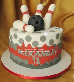 a birthday cake with a bowling ball and skis on top