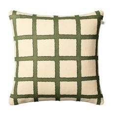 a green and white pillow with squares on it