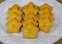 some cookies are shaped like police officers on a white plate with the word sheriff spelled in cursive writing