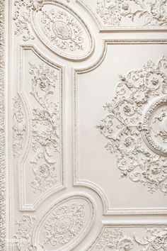 an ornate ceiling with white paint on it