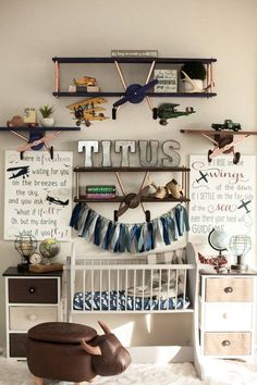 a baby's room with toys and decorations on the wall, including a crib