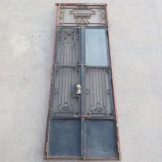 an old iron door on the side of a building