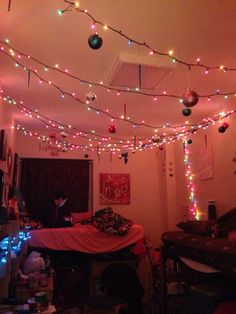 a room filled with lots of christmas lights and decorations hanging from the ceiling above it