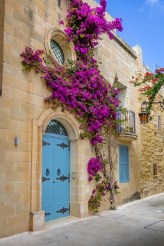 a blue door with purple flowers on it and the words, how to spend a day in