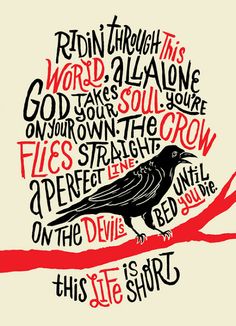 a black bird sitting on top of a tree branch with words written in red and black