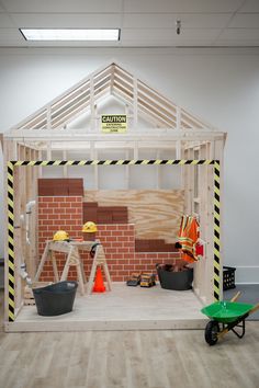 an unfinished room with construction equipment on the floor and around it is a brick wall