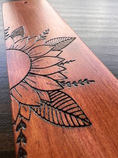 a wooden board with etched designs on it