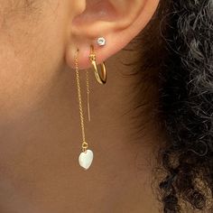 These super cool earrings are versatile and lightweight. They feature a tiny 8mm white mother of pearl hand carved heart that dangles from 3” of 14kt gold filled threader chain including the post. Simply push the post through the pierced hole and pull through to desired length. They come with a rubber stopper so can also be worn as a long dangle post earring once the stopper is put on the post. 14k Gold Filled Threader Earrings As Gift, Single 14k Gold Filled Threader Earring As Gift, 14k Gold Filled Single Threader Earring Gift, Tarnish Resistant Dangle Threader Earrings As Gift, Dainty Tarnish Resistant Threader Earrings As Gift, White Dainty Heart Earrings For Pierced Ears, Gift Tarnish Resistant Dangle Threader Earrings, Dainty White Heart Earrings For Pierced Ears, Tarnish-resistant Dangle Threader Earrings Gift