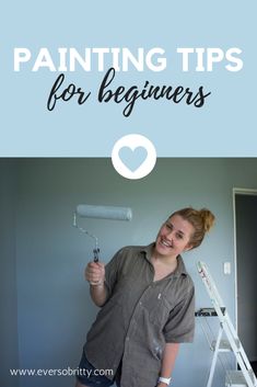 a woman holding a paint roller in her hand with the words, painting tips for beginners