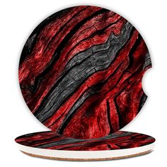 a red and black marble coaster on top of a white plate with an abstract design