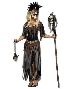 a woman dressed up as a skeleton holding a stick and a skull mask on her head