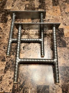 a metal square frame sitting on top of a tiled floor