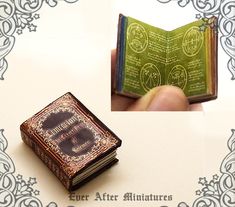 a miniature book is being held in front of the camera