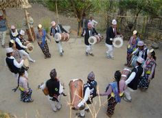 a group of people that are standing around with some drum's in their hands