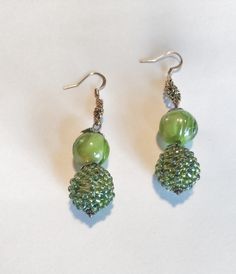 "Green and Gold Dangle Bead Ball Earrings - Lime Green Seed Bead Earrings - Green Elegant Dangle Earrings Handmade earrings are made of a luminescent green bead ball. Bead ball is about 2\" round. Bead ball has a silver toned petal topper bead on top. It is then followed with a green swirl round glass bead followed by another silver toned petal topper bead. Hook is gold colored with a antique swirl flower design. Earring Length: 2 3/4\" long Packaged and wrapped in a beautiful gift box. Perfect for yourself or as a gift.  All items from a smoke-free and pet-free shop." Nickel-free Green Beaded Earrings For Parties, Green Beaded Crystal Earrings, Green Dangle Jewelry With Large Beads, Green Crystal Drop Earrings With Dangling Beads, Czech Glass Earrings With Dangling Round Beads, Green Beaded Earrings With Round Beads, Green Beaded Earrings With Large Beads For Gift, Green Beaded Earrings With Czech Glass, Green Czech Glass Beaded Earrings