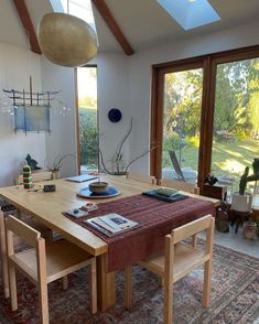 a dining room table with chairs and a rug on the floor in front of it