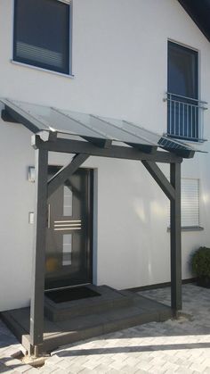 a white building with a black door and some windows