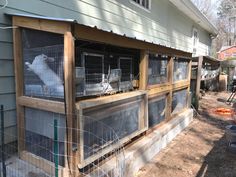 an outside view of a house with some animals in it