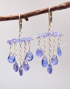 Absolutely gorgeous periwinkle Tanzanite makes a bold statement in these unique chandelier earrings. These are very eye catching! Tanzanite is a rare stone that is prized for its unique color. It is a birthstone of December. These are a great addition to any collection, and are sure to become favorites. The stones sway and move, catching the light. These are truly so pretty on! Photos don't capture them adequately. They are a great party Earrings for holidays.  These beauties hang 2" long on sec Unique Chandelier, Unique Chandeliers, Ocean Jewelry, Beads Bracelet Design, Rare Stone, Made Jewelry, Bracelet Design, Party Earrings, December Birthstone