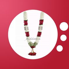 a red and white necklace with flowers on it next to two circles in the background