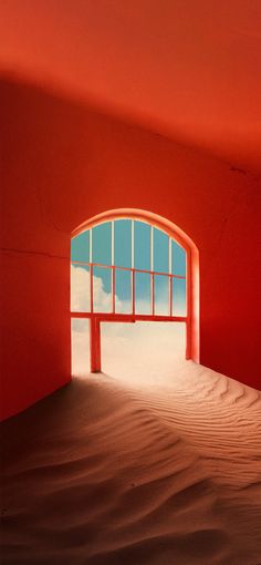 an open window in the middle of a desert with sand dunes and blue sky behind it