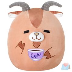 a stuffed animal with horns holding a coffee cup in it's mouth and eyes