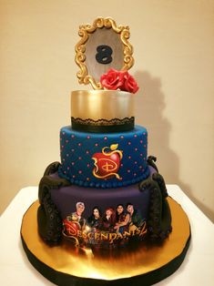 a three tiered cake is decorated with disney characters and the number eight on it