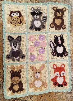 a crocheted blanket with many different animals on it's sides, including an owl, raccoon, fox, and bear