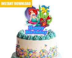 the little mermaid birthday cake is decorated with sprinkles and an edible topper