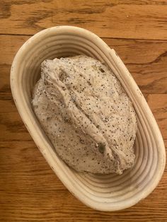 a bowl filled with something on top of a wooden table