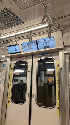 the inside of a subway car with doors open