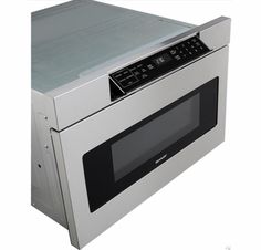 a silver microwave oven sitting on top of a white countertop with the door open