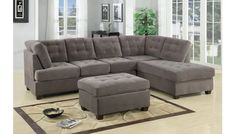 a living room with a sectional couch and ottoman