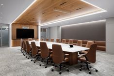 an empty conference room with many chairs and a flat screen tv on the wall above it