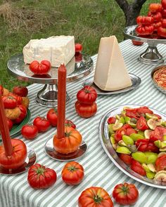 a table topped with lots of different types of food on top of metal trays