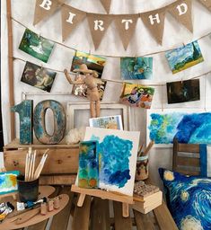 an artist's studio with paintings and art supplies