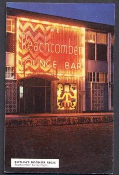 an old photo of a building lit up at night with the words baachcombel lounge bar on it