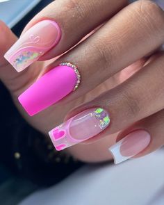 a woman's hand with pink and white manies on it, holding onto her nails