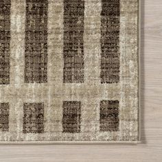 a brown and white area rug on top of a wooden floor